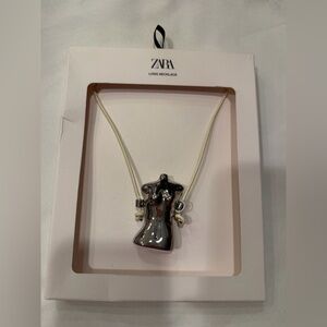 Zara. Leather necklace with bust charm